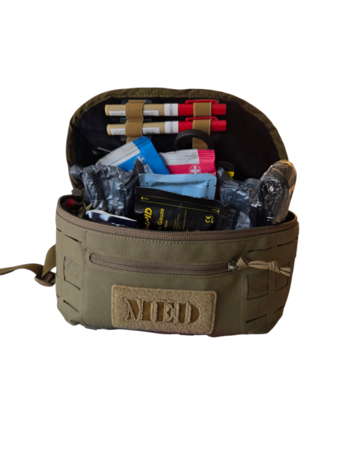 Interior of olive green MED first aid pouch packed with trauma supplies including Celox, Israeli 6", and Vented Chest Seal